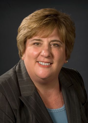 Terry Pando, RN, wearing a striped suit